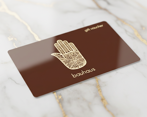 Gift voucher with Hamsa hand design on a marble surface